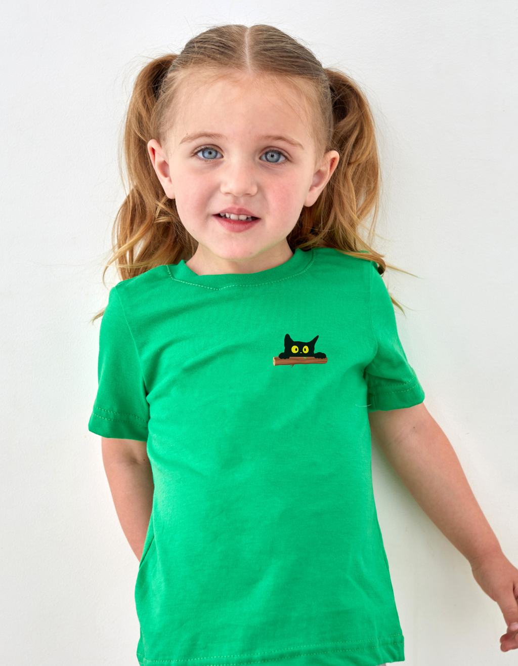 Child wearing Peek-a-Meow cotton T-shirt with cute cat design