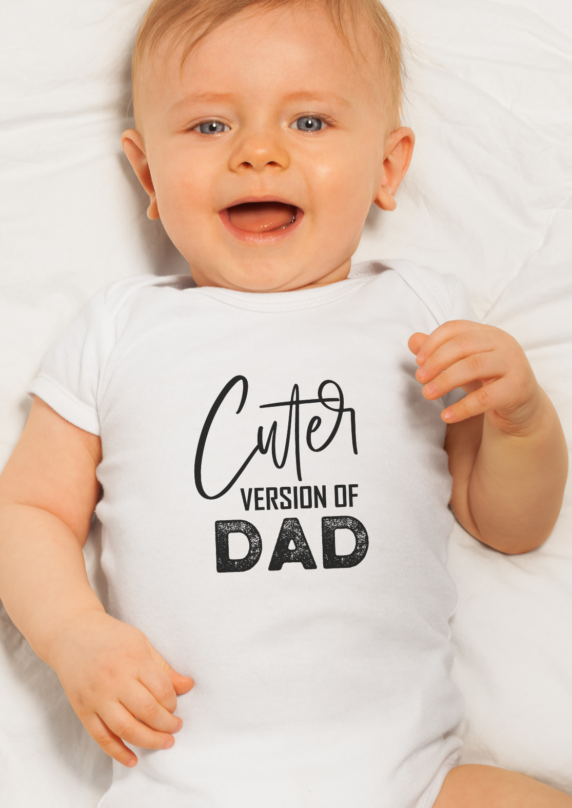 Baby wearing a white onesie with 'Cutter version of Dad' text on a white background