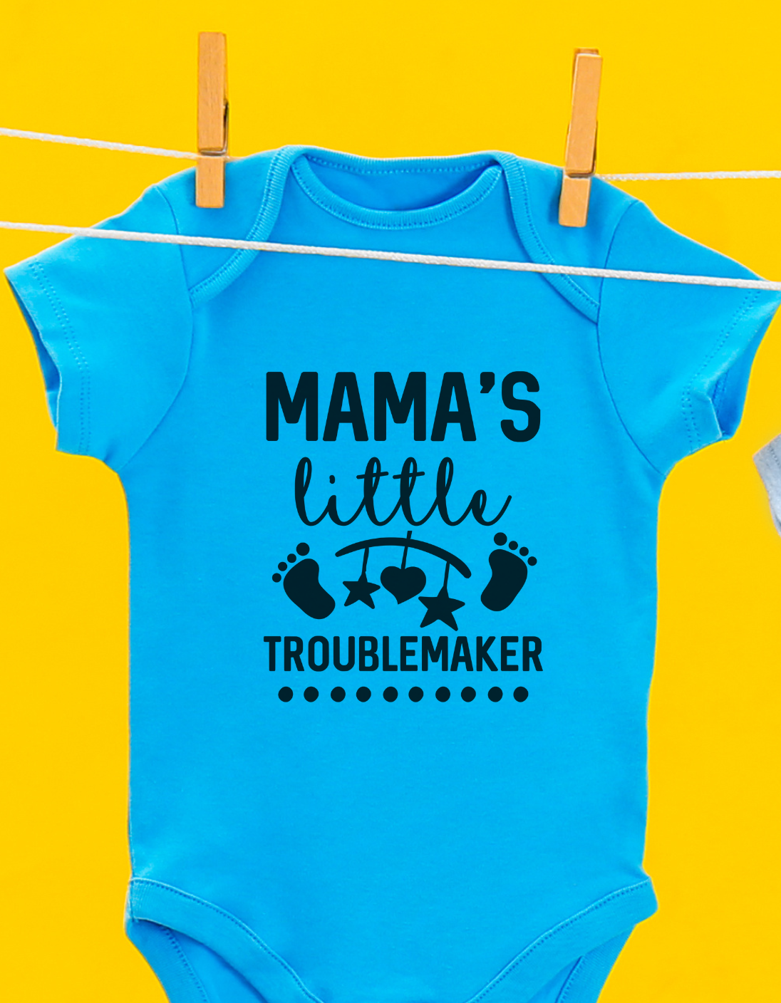 Blue baby onesie with 'Mama's little troublemaker' text on a yellow background
