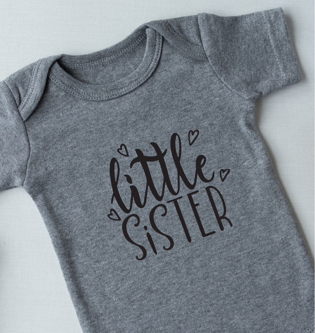 Gray 'little sister' onesie with a plush toy on a light background