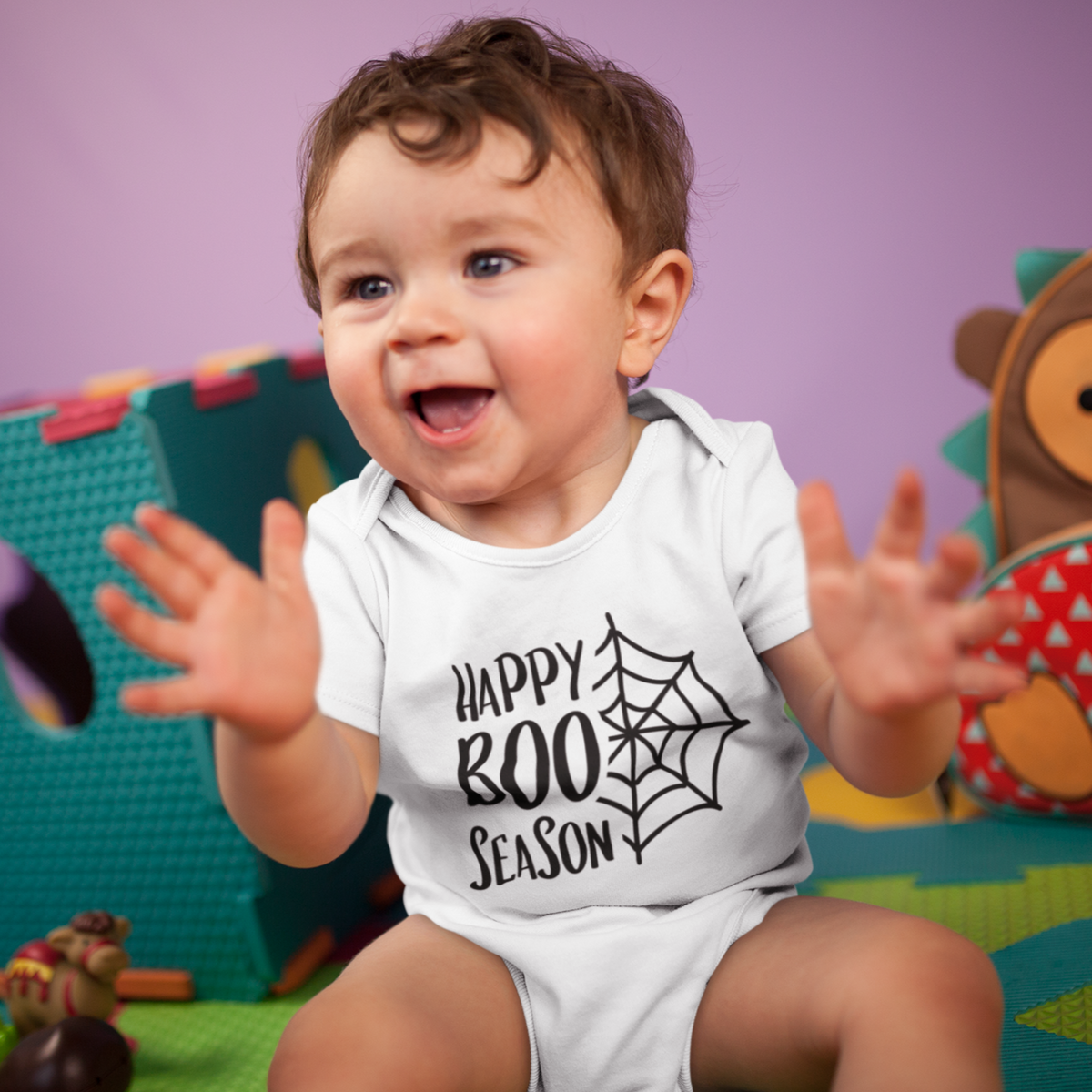"Baby wearing Halloween cotton romper with spider web and Happy Boo Season print"