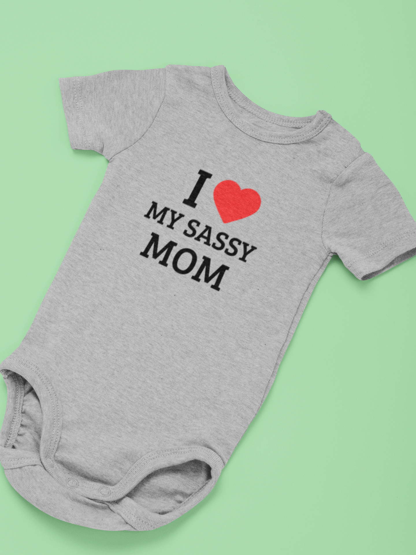 Baby wearing cotton onesie with “I Love My Sassy Mom” print by Mumma’s Cub