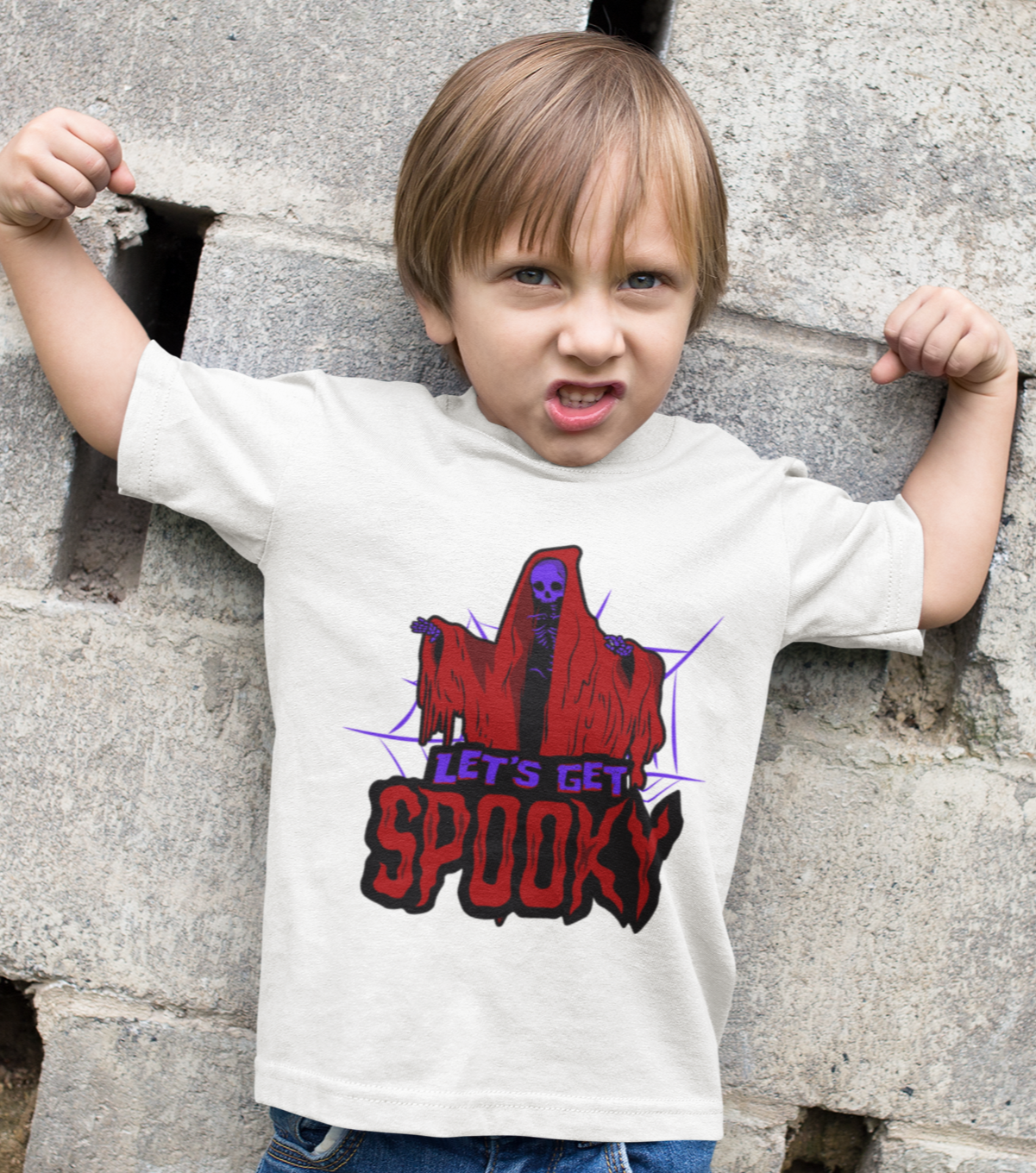 Kids unisex cotton Halloween T-shirt with skeleton in hooded shrug and text “Let’s Get Spooky”