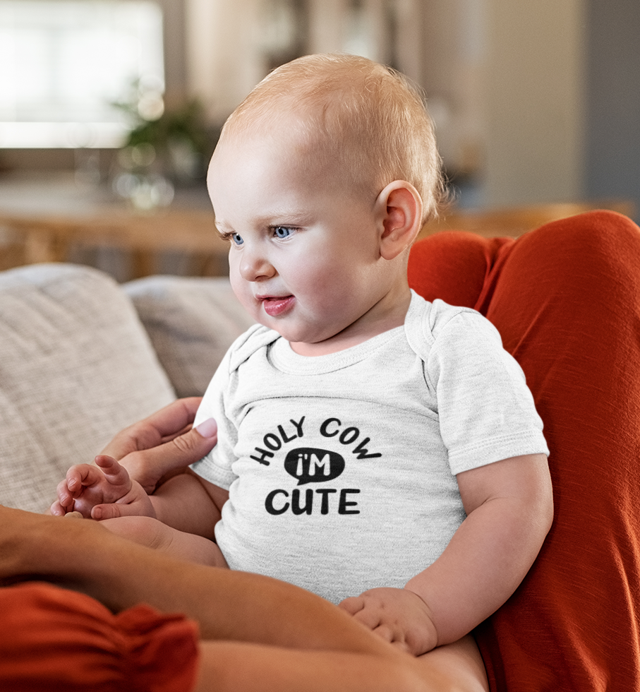Baby wearing super combed cotton romper with “Holy cow I’m cute” quote by Mumma’s Cub