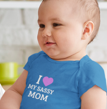 Baby wearing cotton onesie with “I Love My Sassy Mom” print by Mumma’s Cub